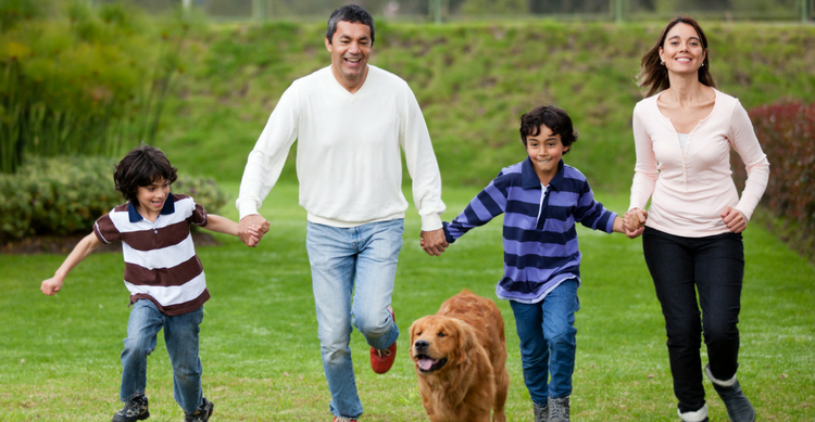 family in the park with dog