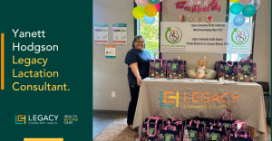 Yanett Hodgson, Legacy Lactation Consultant, stands beside a Legacy Community Health table with balloons and gift bags at a community health event.