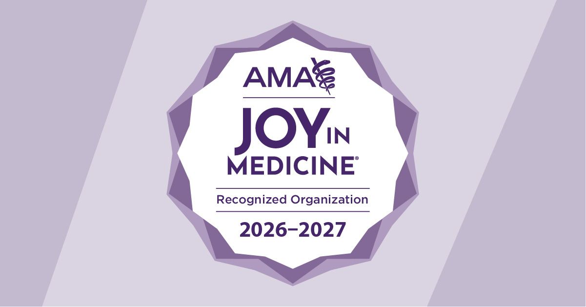 Badge displaying the logo and text: "AMA Joy in Medicine Recognized Organization 2026-2027." The badge is set against a purple background with a ribbon featuring the Rod of Asclepius symbol.